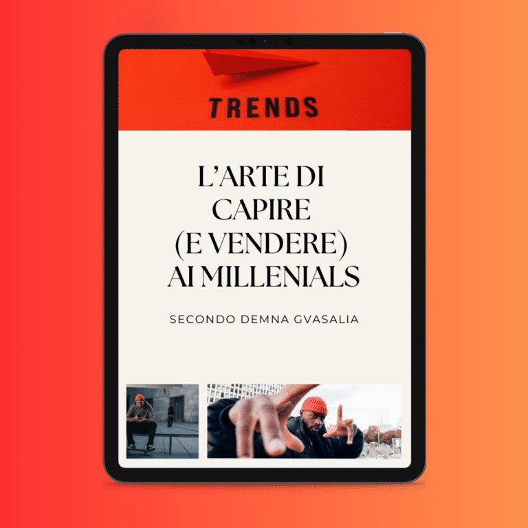 The screen of a tablet shows a red and white page with the Italian text 'L'Arte di Capire (e Vendere) ai Millenials' and two photos of individuals underneath, highlighting that it is all about style to beat the crisis.
