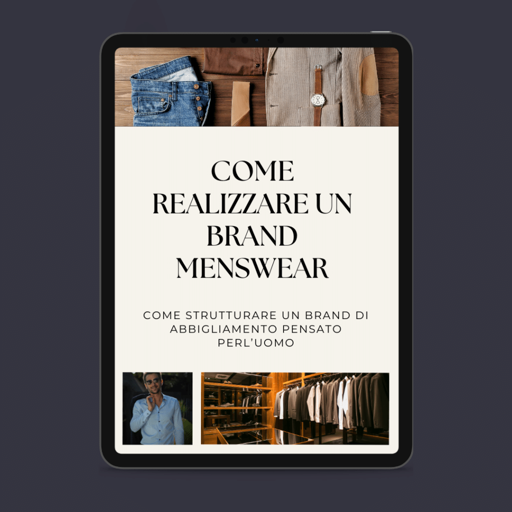 Une tablette montrant un guide italien intitulé "Comment créer une marque de vêtements pour hommes" avec des photos de costumes, d'un homme en costume et d'une armoire, soulignant que surmonter la crise est toujours une question de style.