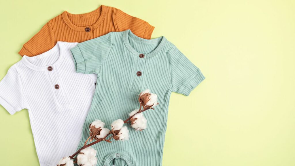 Three cotton rompers on a yellow background in a resort cruise collection.