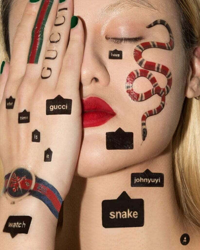 A woman with an iconic snake tattooed on her face.