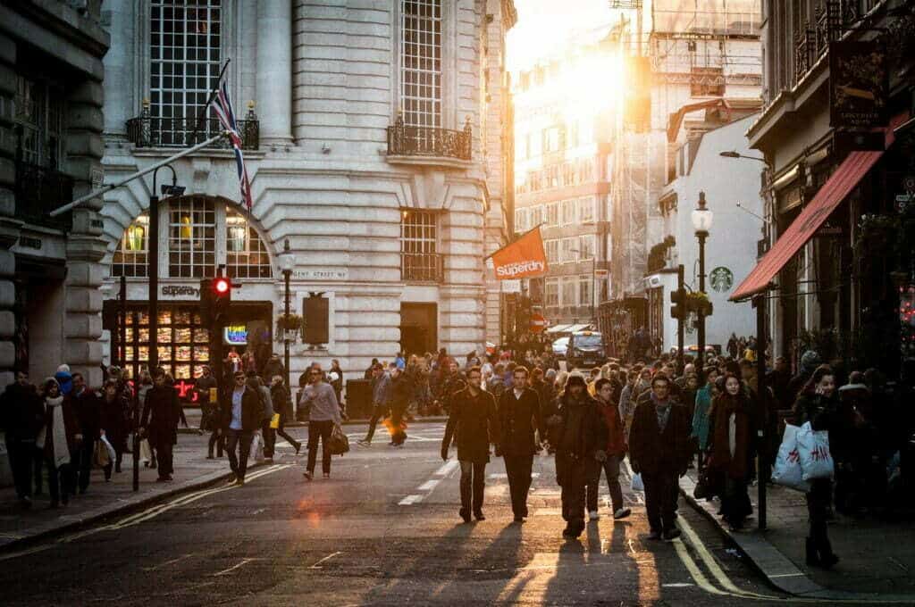 Une foule de personnes marchant dans une rue de Londres observée depuis les coulisses.
