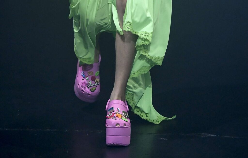 A woman wearing pink shoes on a viral catwalk.