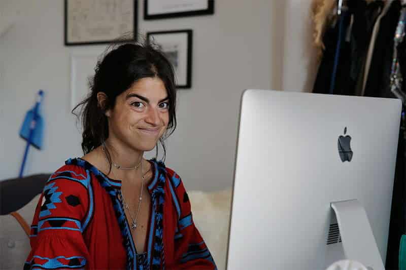 A woman is sitting in front of a computer.