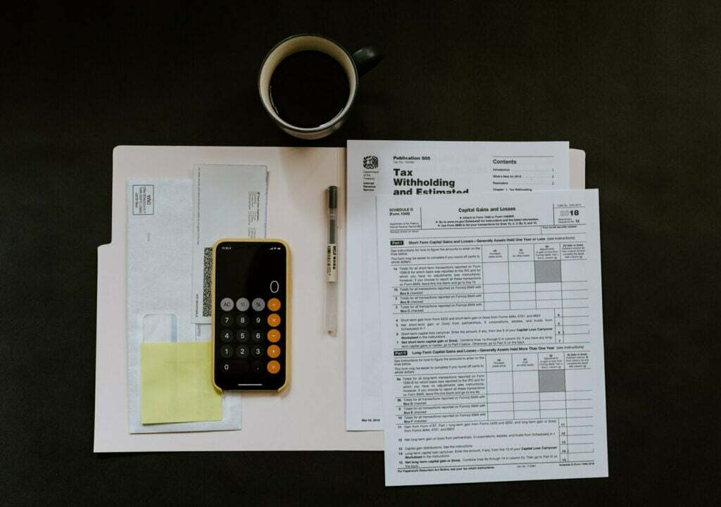 A desk decorated with a telephone and documents showcases the best production methods of the fashion industry.