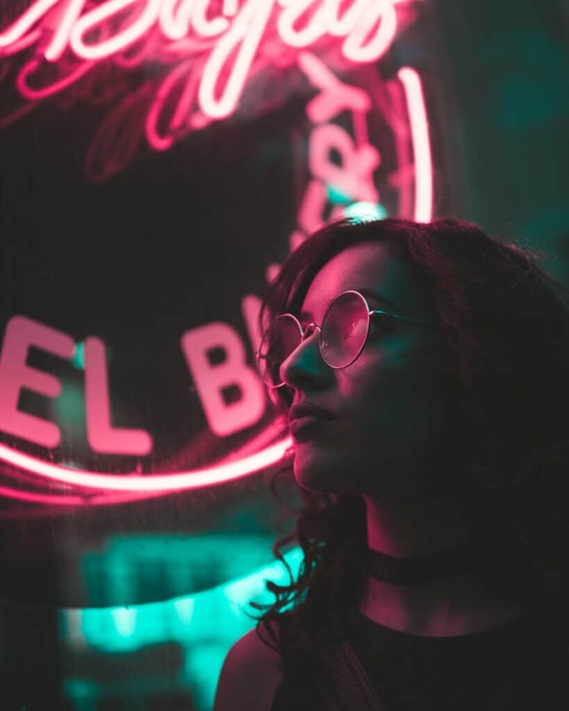 A cool hunting pro in front of a neon sign.