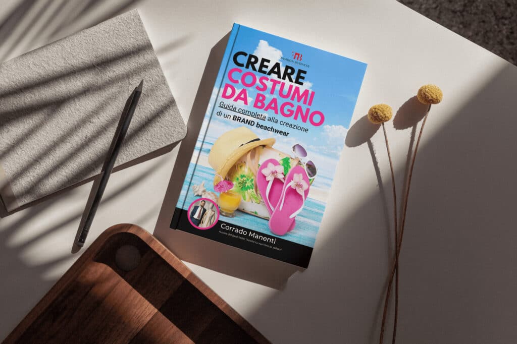 Un libro titulado "¿Cómo se crea una línea de trajes de baño?" sobre una mesa.