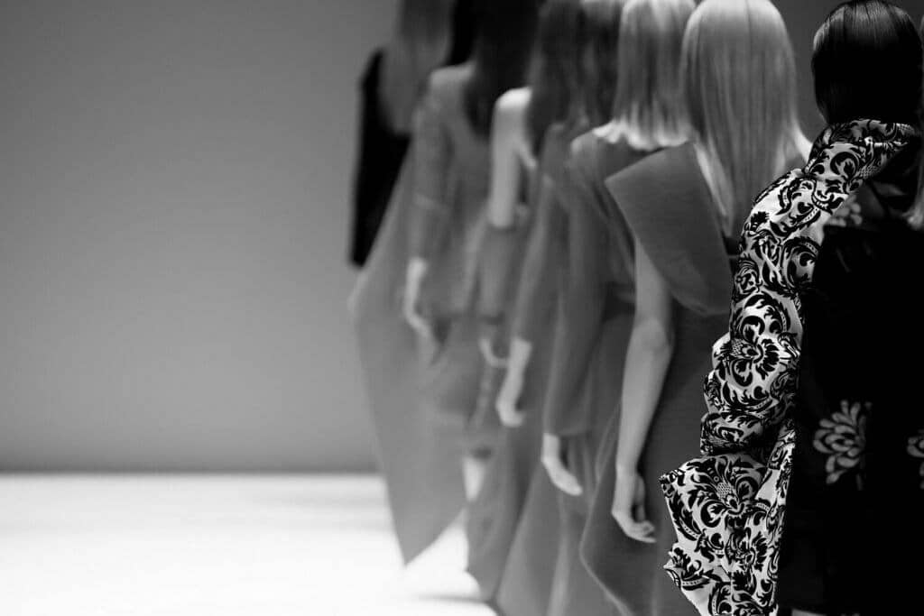 A group of women on a catwalk showing fashion models during the COVID-19 year.