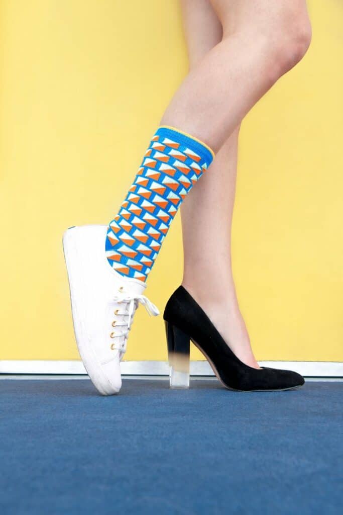 A pair of fashionable legs with fashionable shoes inspired by new designers.