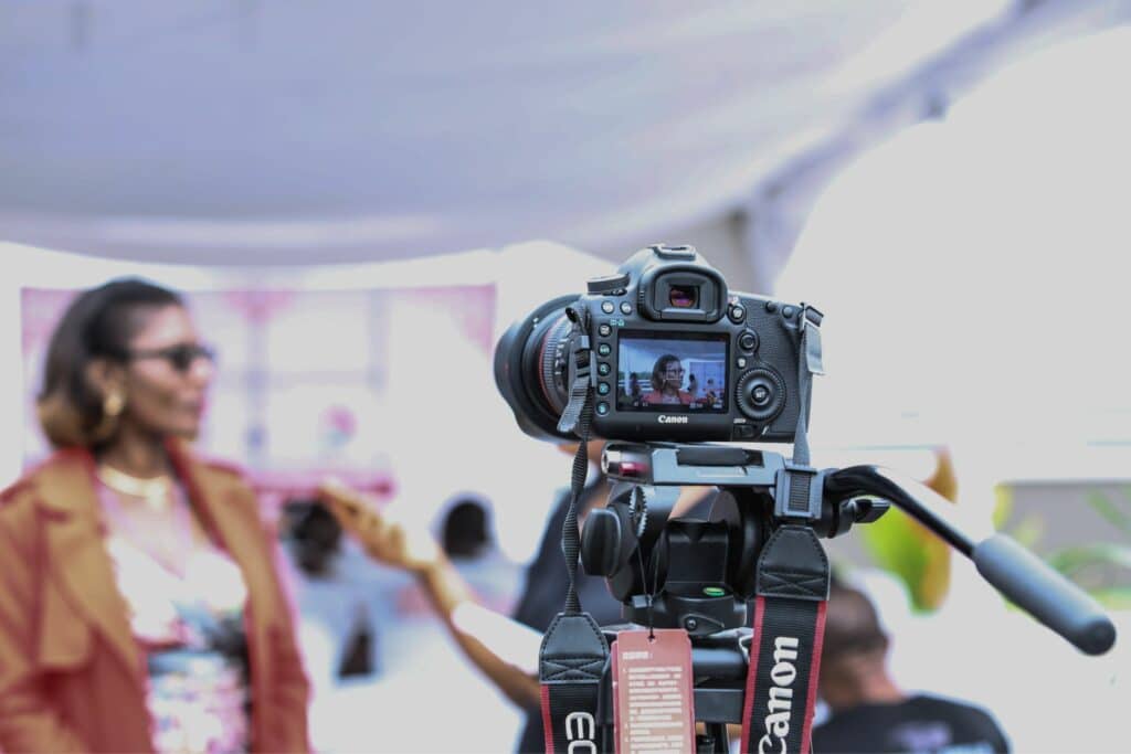 A woman is taking a photo with a camera for service purposes.