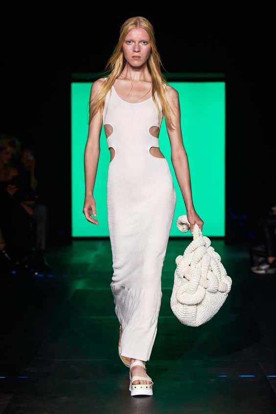 A model sports an iconic white dress on the fashion catwalk in 2023.