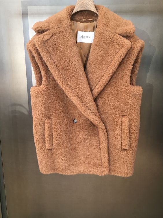 An iconic brown plush jacket hanging on a hanger.