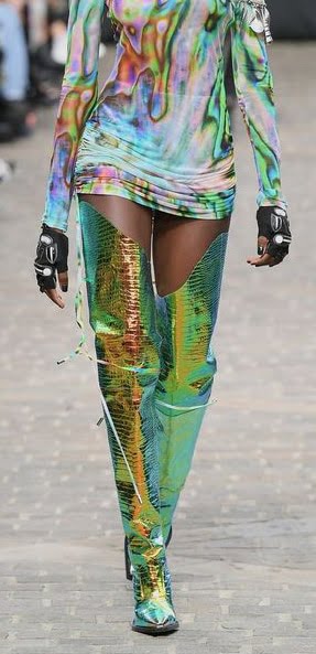 A woman showing fashionable boots on the runway.