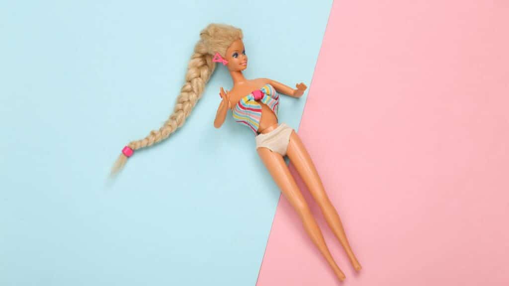 Barbie doll on pink background.