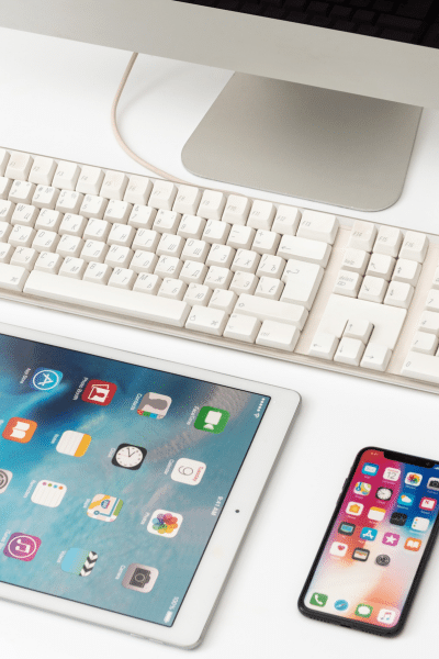 An iPad and a keyboard on a white surface with an iPad Pro and an iPad Mini.