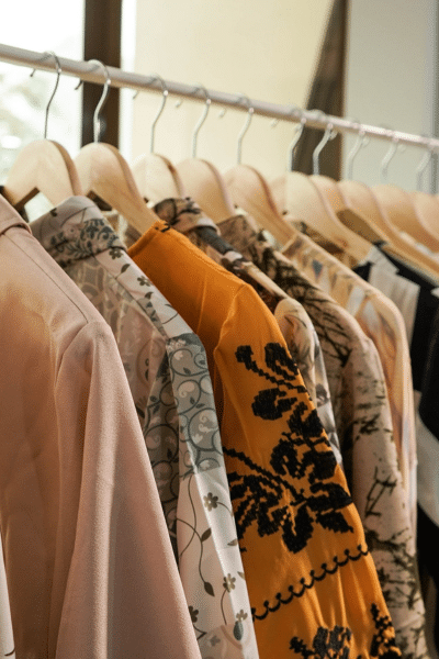 A collection of T-shirts hung on a rack.