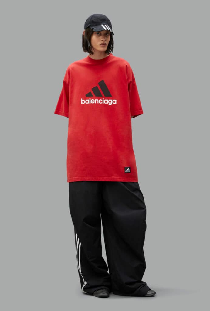 A woman wearing a red adidas T-shirt.
