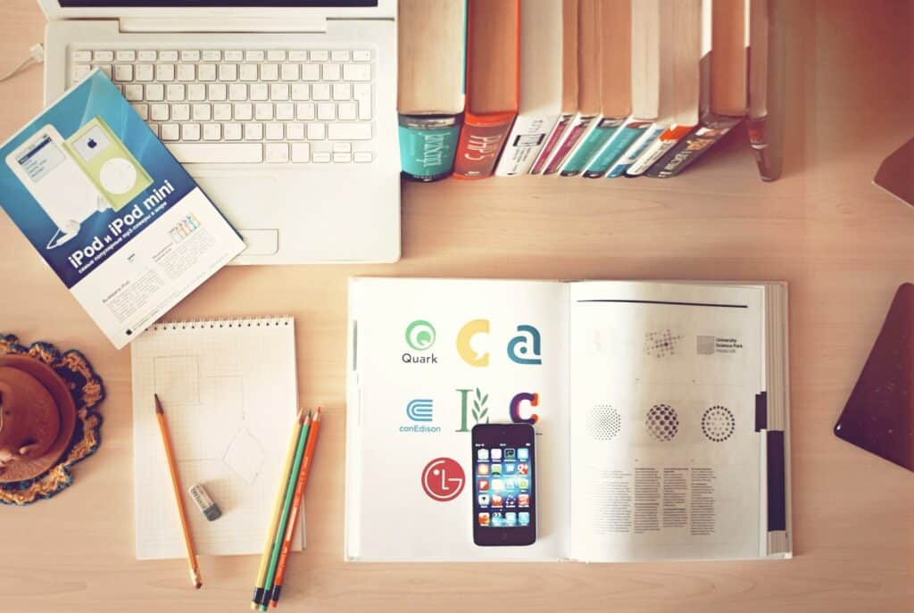 pencils and smartphones on top of books