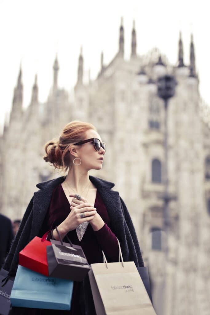 Shallow Focus Photography of Woman Holding Assorted-color Paper Bags